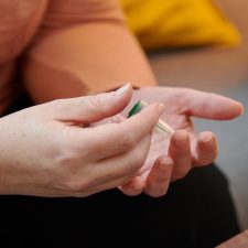 Pricking finger with cuvette to collect blood sample